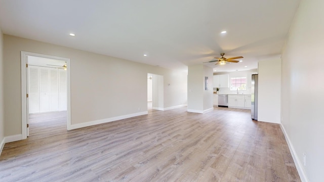 unfurnished living room featuring ceiling fan and light hardwood / wood-style floors