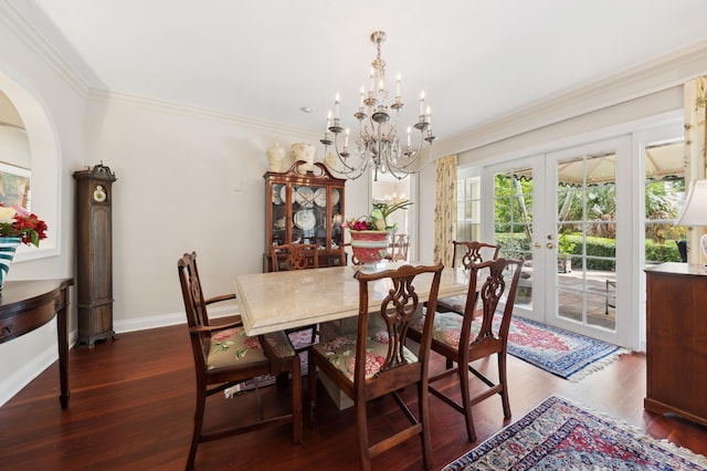 dining space featuring dark hardwood / wood-style flooring, french doors, a notable chandelier, and ornamental molding