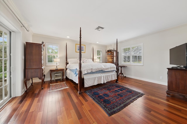 bedroom with crown molding and dark wood-type flooring