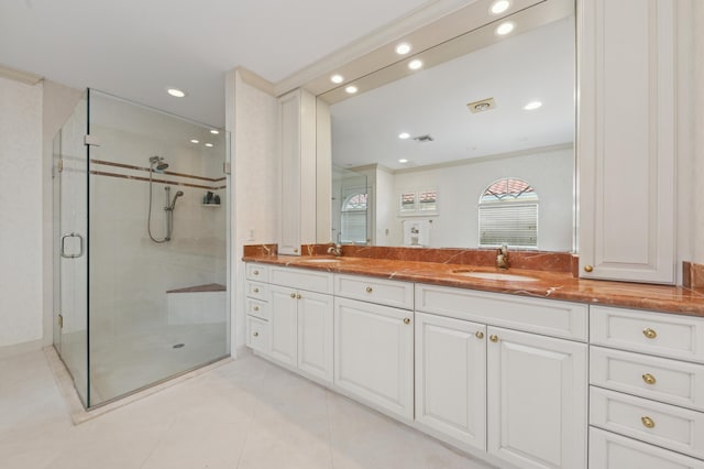 bathroom featuring tile patterned flooring, vanity, a shower with door, and ornamental molding