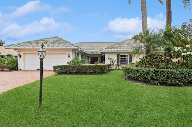 view of front of home featuring a garage and a front yard