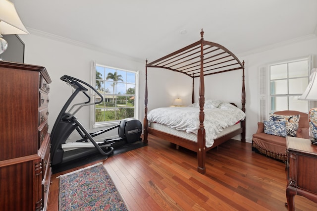 bedroom featuring dark hardwood / wood-style flooring and crown molding