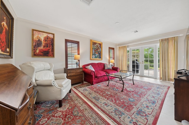 tiled living room with ornamental molding and french doors