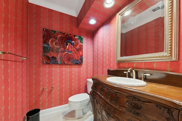 bathroom with tile patterned floors, vanity, toilet, and ornamental molding