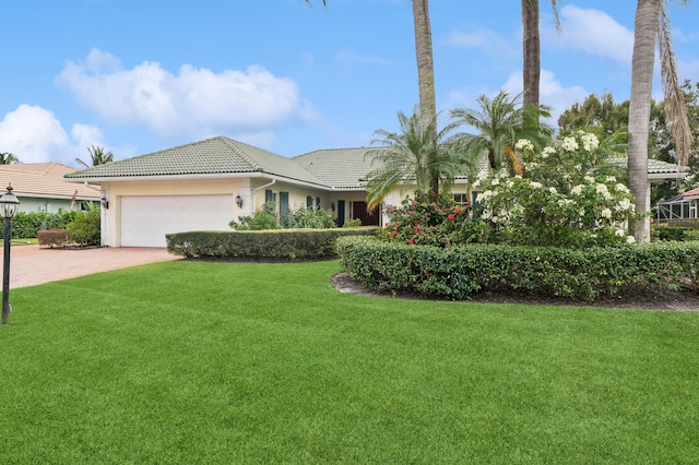 view of front of home featuring a garage and a front lawn