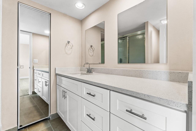 bathroom with tile patterned floors, vanity, and a shower with shower door