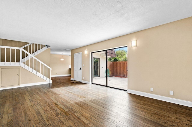 unfurnished living room with hardwood / wood-style floors and a textured ceiling