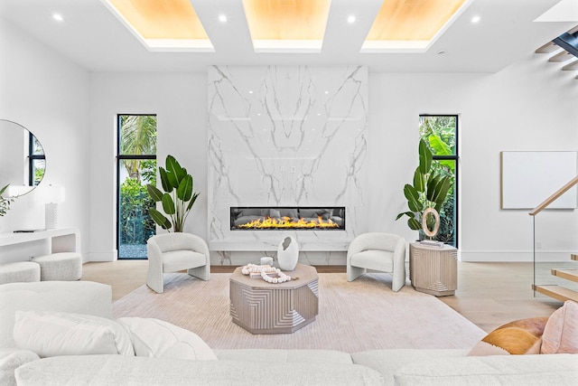 living room with a fireplace, a healthy amount of sunlight, and light hardwood / wood-style flooring