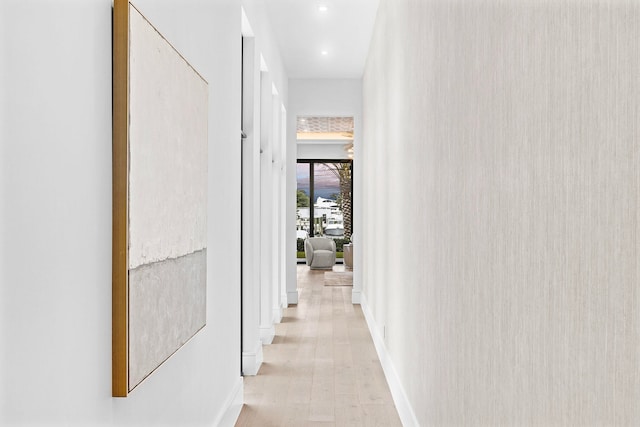 corridor with light wood-type flooring