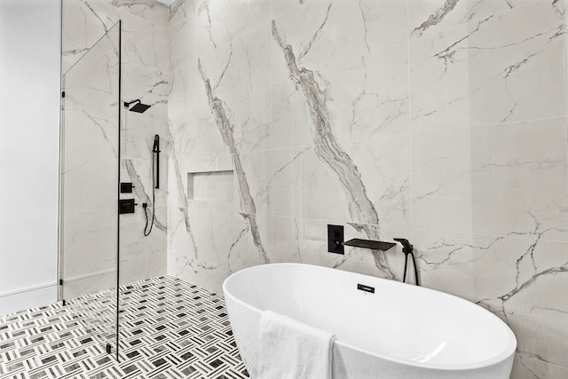 bathroom featuring tile walls and independent shower and bath