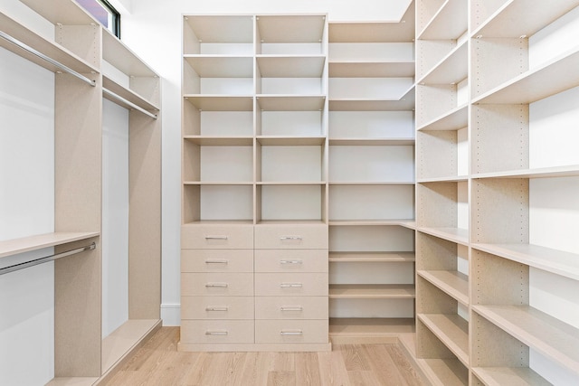 spacious closet with light hardwood / wood-style floors