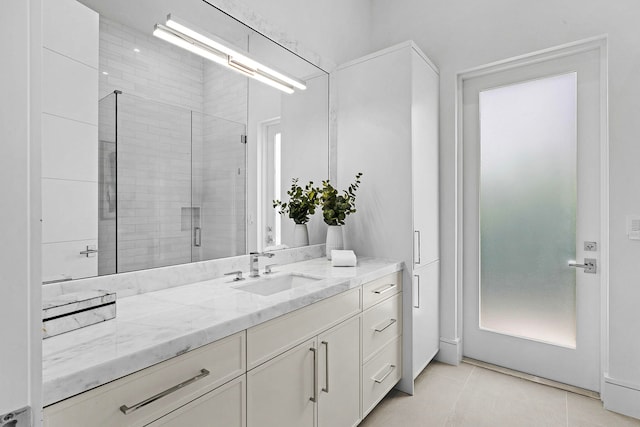 bathroom with vanity, tile patterned floors, and a shower with shower door