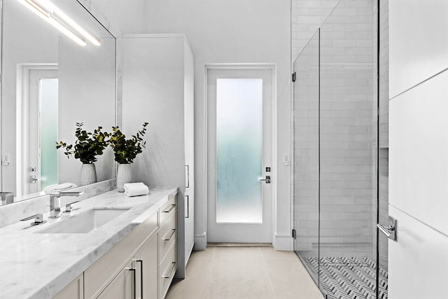 bathroom featuring vanity, walk in shower, and tile patterned floors