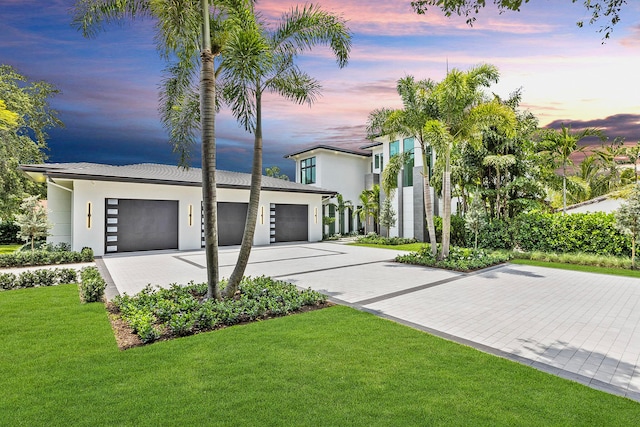 modern home with a garage and a yard