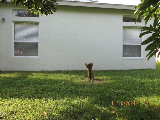 view of property exterior with a yard