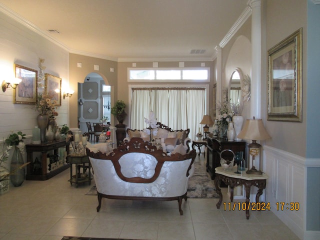 living room with light tile patterned flooring and ornamental molding