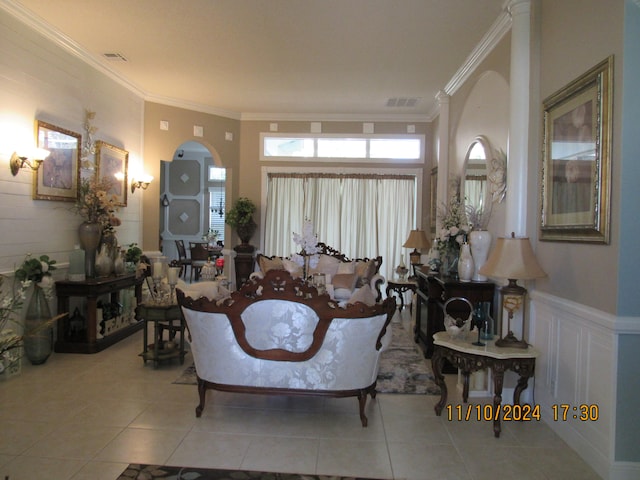 living room with light tile patterned floors and crown molding