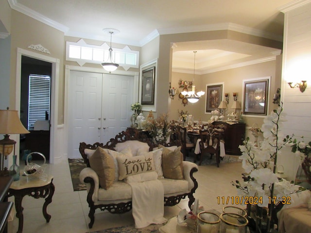 living room with light tile patterned flooring, a chandelier, and ornamental molding