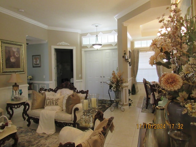 living room with light tile patterned floors and ornamental molding