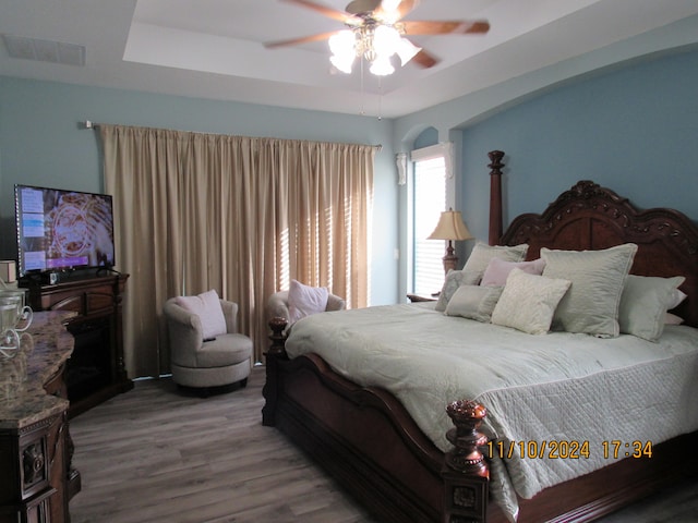 bedroom with hardwood / wood-style flooring and ceiling fan