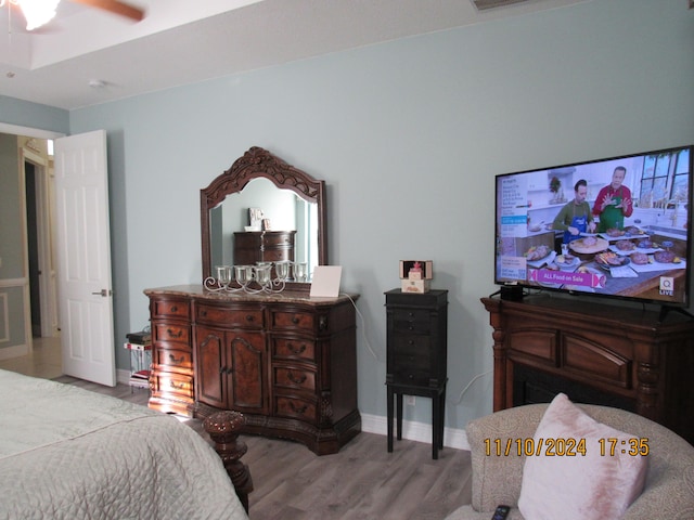 bedroom with light hardwood / wood-style floors and ceiling fan