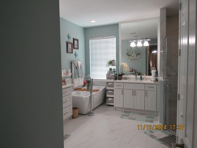 bathroom featuring vanity and separate shower and tub