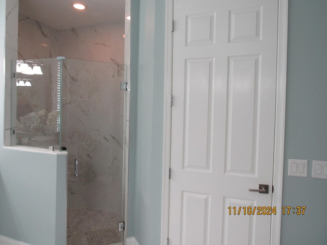 bathroom with a shower with door