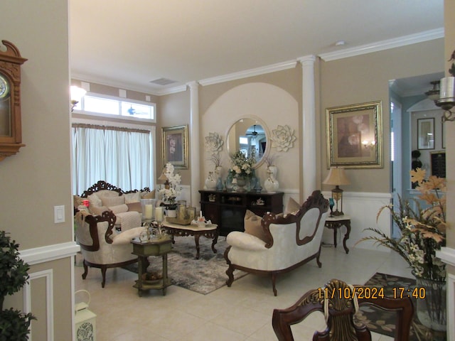 living room with ornamental molding and ornate columns