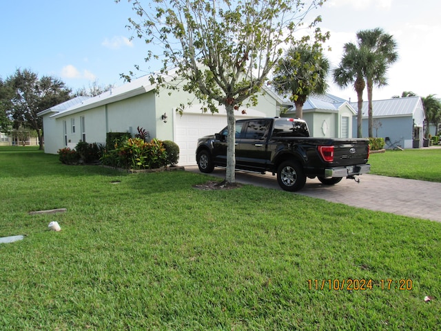 view of property exterior with a garage and a yard