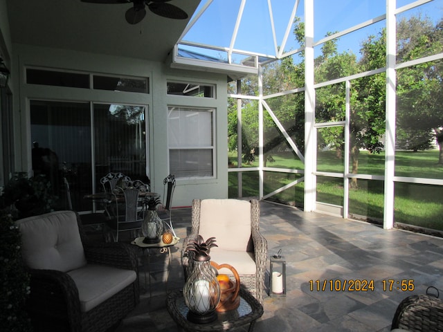 sunroom / solarium featuring a healthy amount of sunlight and ceiling fan