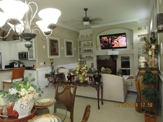 living room with light tile patterned flooring, ceiling fan, and ornamental molding