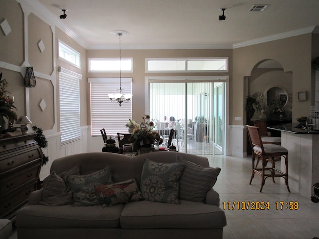 tiled living room with an inviting chandelier and ornamental molding