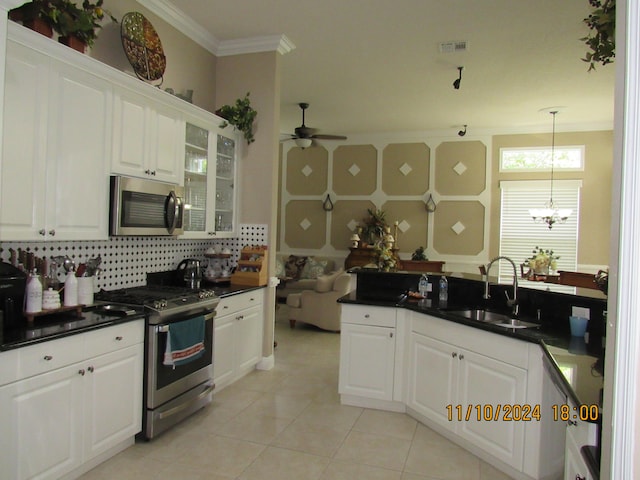 kitchen with appliances with stainless steel finishes, sink, and white cabinets