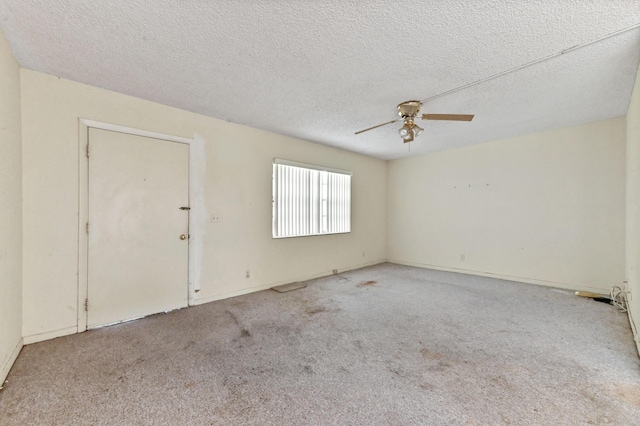 empty room with a textured ceiling, ceiling fan, and light colored carpet