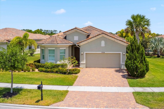 mediterranean / spanish-style home featuring a garage and a front lawn