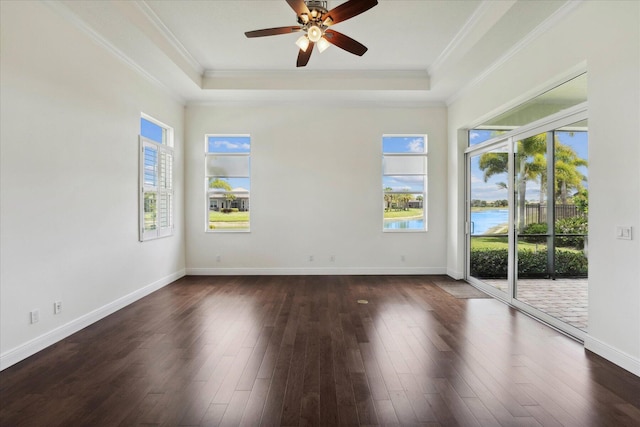 empty room with dark hardwood / wood-style flooring, a water view, crown molding, and plenty of natural light