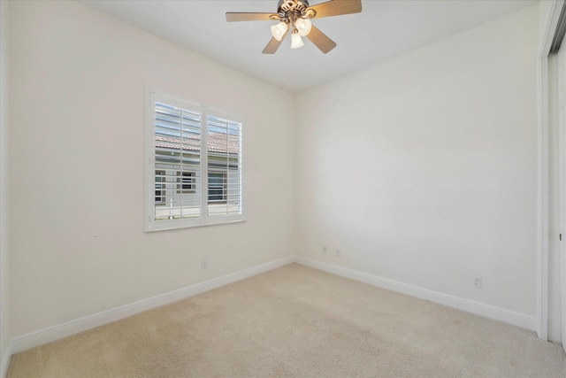 spare room with light carpet and ceiling fan