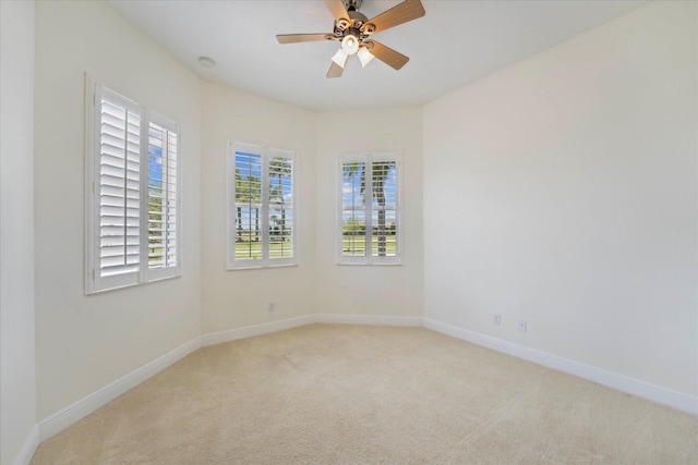 unfurnished room with ceiling fan and light carpet