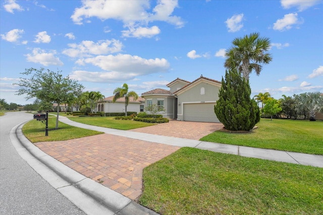 mediterranean / spanish home featuring a front lawn and a garage