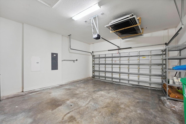 garage with a garage door opener and electric panel