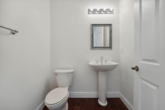 bathroom featuring wood-type flooring and toilet