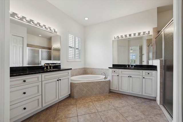 bathroom featuring vanity, plus walk in shower, and tile patterned floors