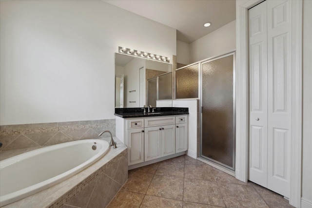 bathroom featuring independent shower and bath, tile patterned flooring, and vanity