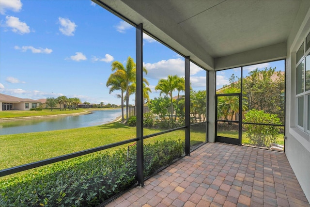 unfurnished sunroom featuring a water view