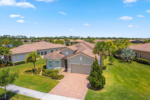 mediterranean / spanish home with a garage and a front yard