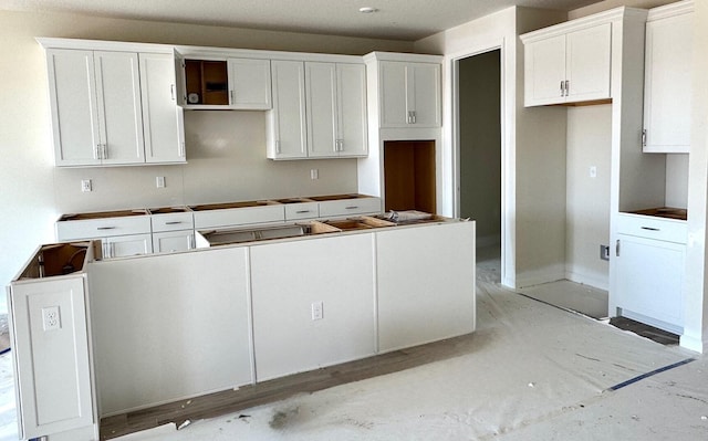 kitchen featuring white cabinets and a center island