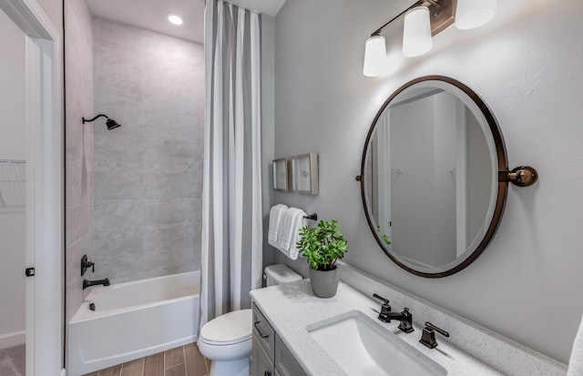 bathroom featuring wood finished floors, toilet, vanity, and shower / bathtub combination with curtain