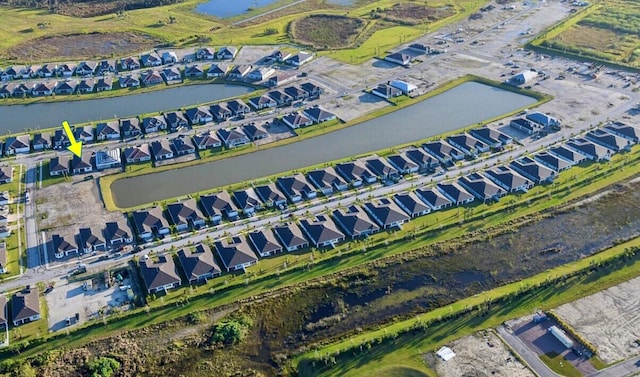 birds eye view of property with a residential view and a water view