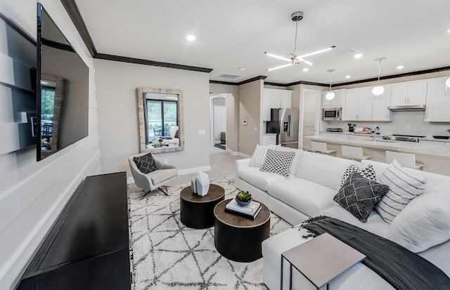 living area featuring visible vents, recessed lighting, crown molding, and baseboards