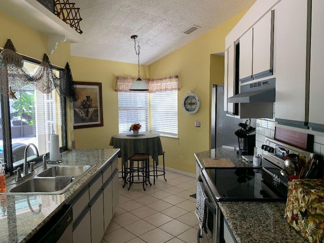 kitchen with white cabinets, hanging light fixtures, sink, a textured ceiling, and appliances with stainless steel finishes